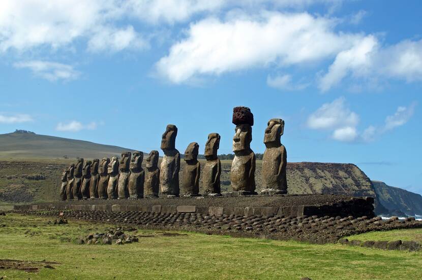 Sculptures on Easter Island with meadows in the background