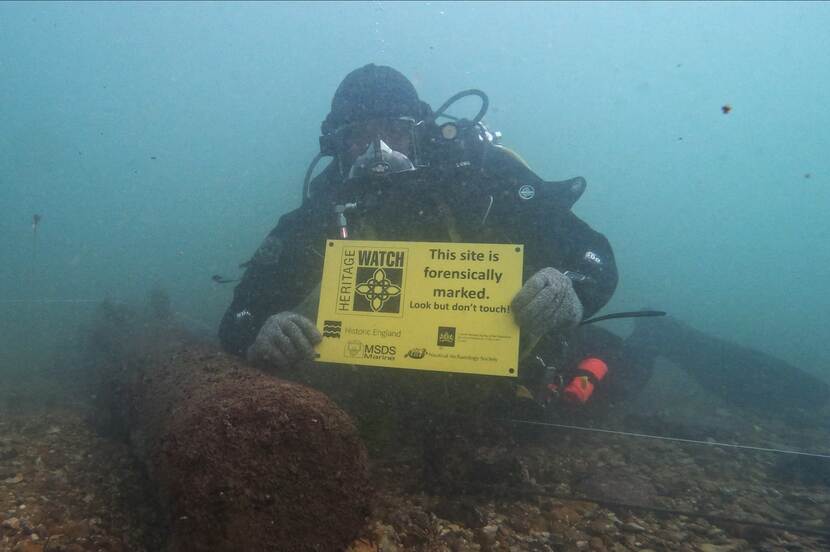 Diver holds up a yellow sign