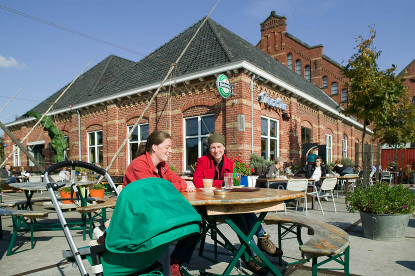 Mensen op het horeca terras op het Westergasfabriek terrein