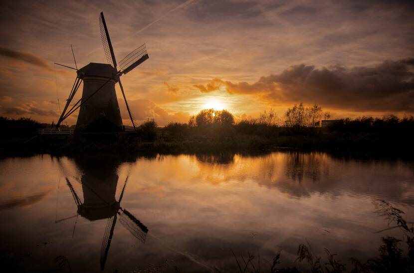 Een molen bij zonsondergang.