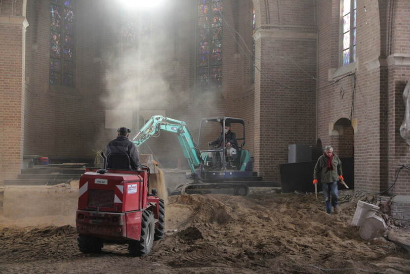 Graafmachines graven in de grond in een kerk.